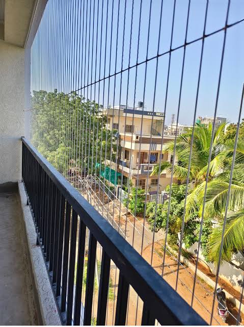 Modern custom-fitted invisible grill design by Renu Invisible Grills in Bengaluru
